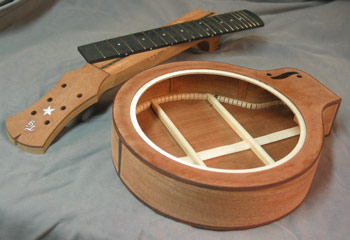 Photo of Requintonator 15 showing the assembled body with binding, neck headstock with inlay, and fingerboard